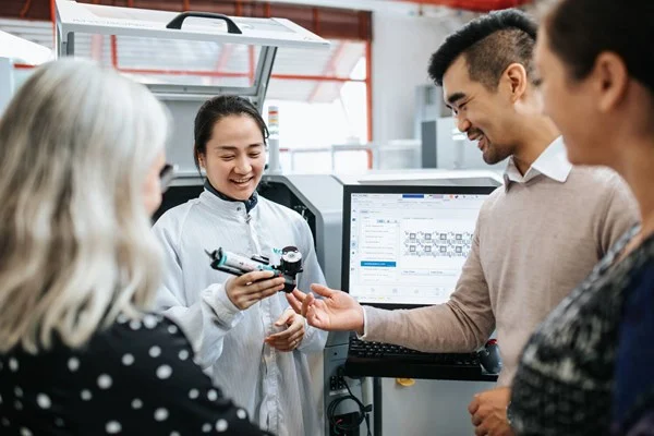 Employee showing the jet printer to customers
