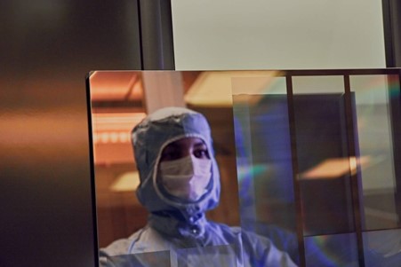 A woman mirroring herself in a display 